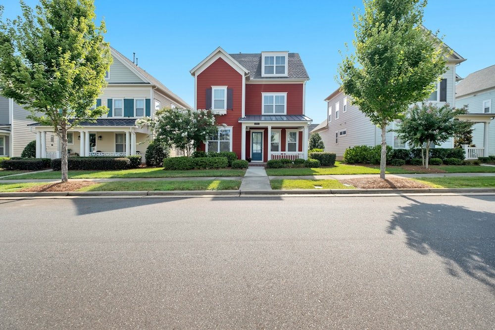 Suburban home exterior with a green lawn and trees