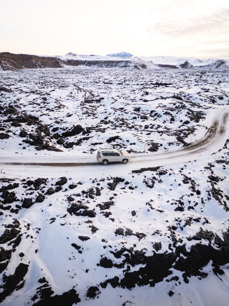 Car driving on a snowy road in winter